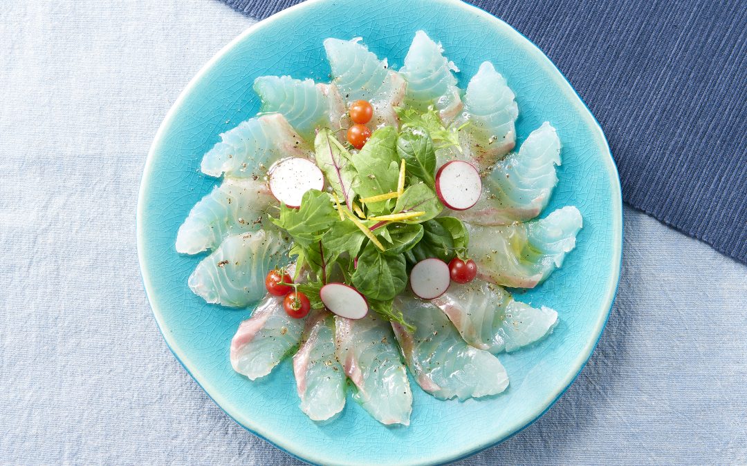 Sea bream carpaccio with baby greens, cherry tomatoes, olive oil, and Momiji Oroshi Ponzu