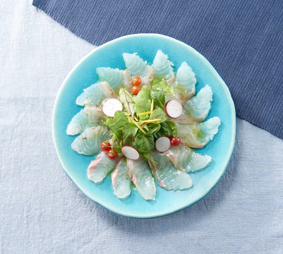 Sea bream carpaccio with baby greens, cherry tomatoes, olive oil, and Momiji Oroshi Ponzu